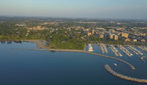 An areal view of Kenosha, WI, in Kenosha County - Boats are docked in the water, there's a view of the city that stretches to the horizon of blue skies