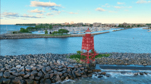 Racine, in Racine County - Lighthouse, and boats at the dock, city view with blue skies